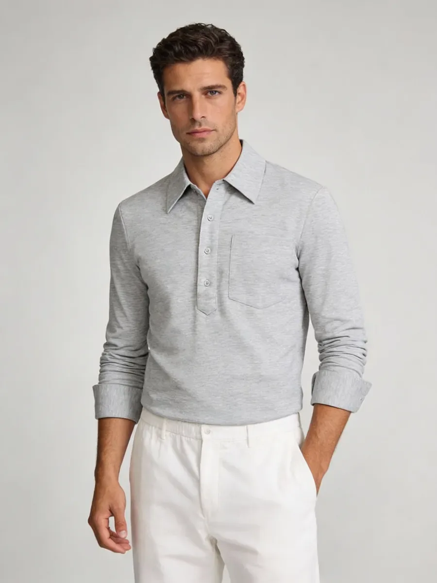 Grey long-sleeve knit polo worn with cream trousers