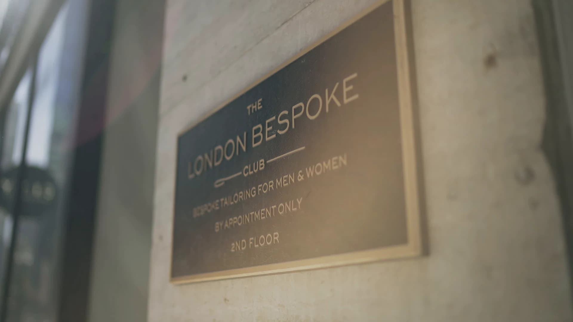 The London Bespoke Club brass sign: by appointment only, second floor.