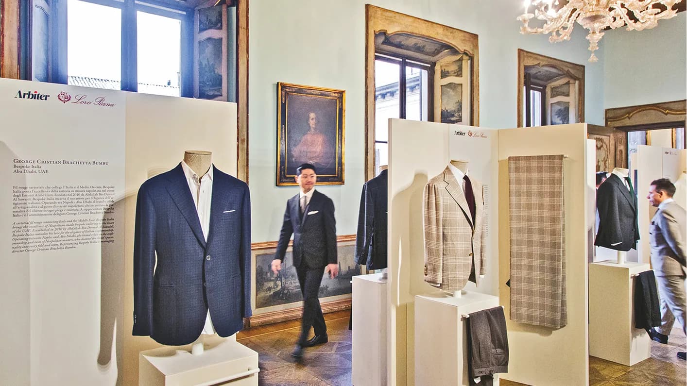 Tailored garments displayed in the ornate rooms of Milano su Misura