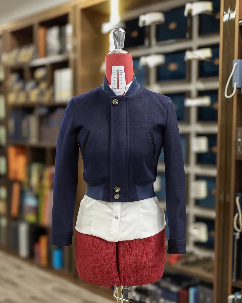 Cropped navy women’s jacket with a standing collar displayed on a mannequin