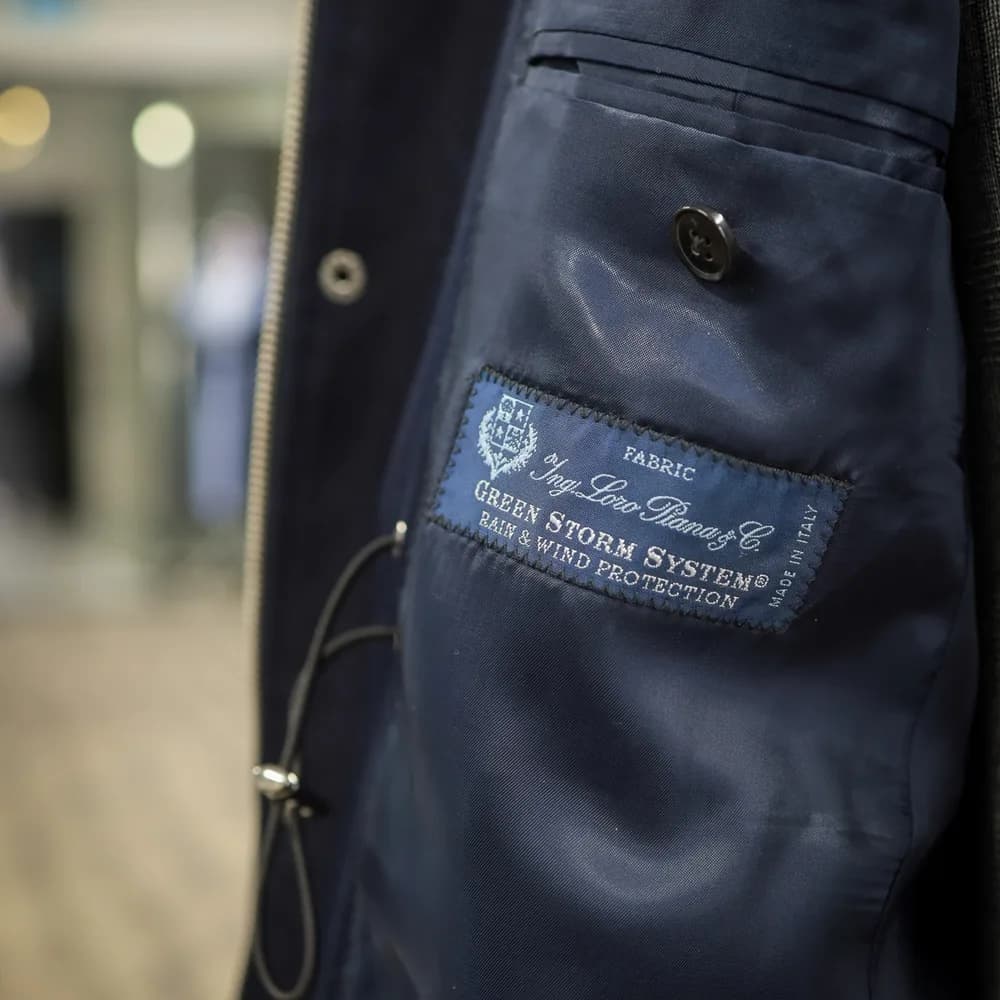Navy coat lining and interior pocket with a Loro Piana Green Storm System fabric label