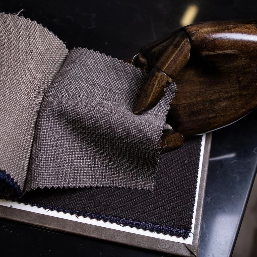 Layered woven cloth swatches in warm brown and soft grey