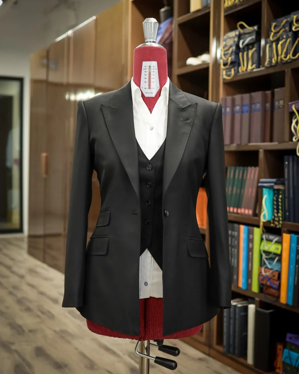 Women’s jacket and matching waistcoat styled over a white shirt at the atelier