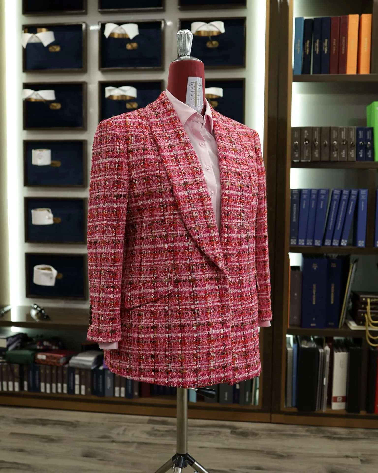 Pink textured women’s jacket and matching skirt, styled with a pale pink shirt at the atelier