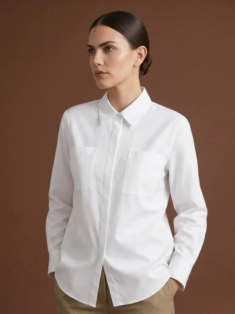 Relaxed white shirt with chest pockets worn with tan trousers