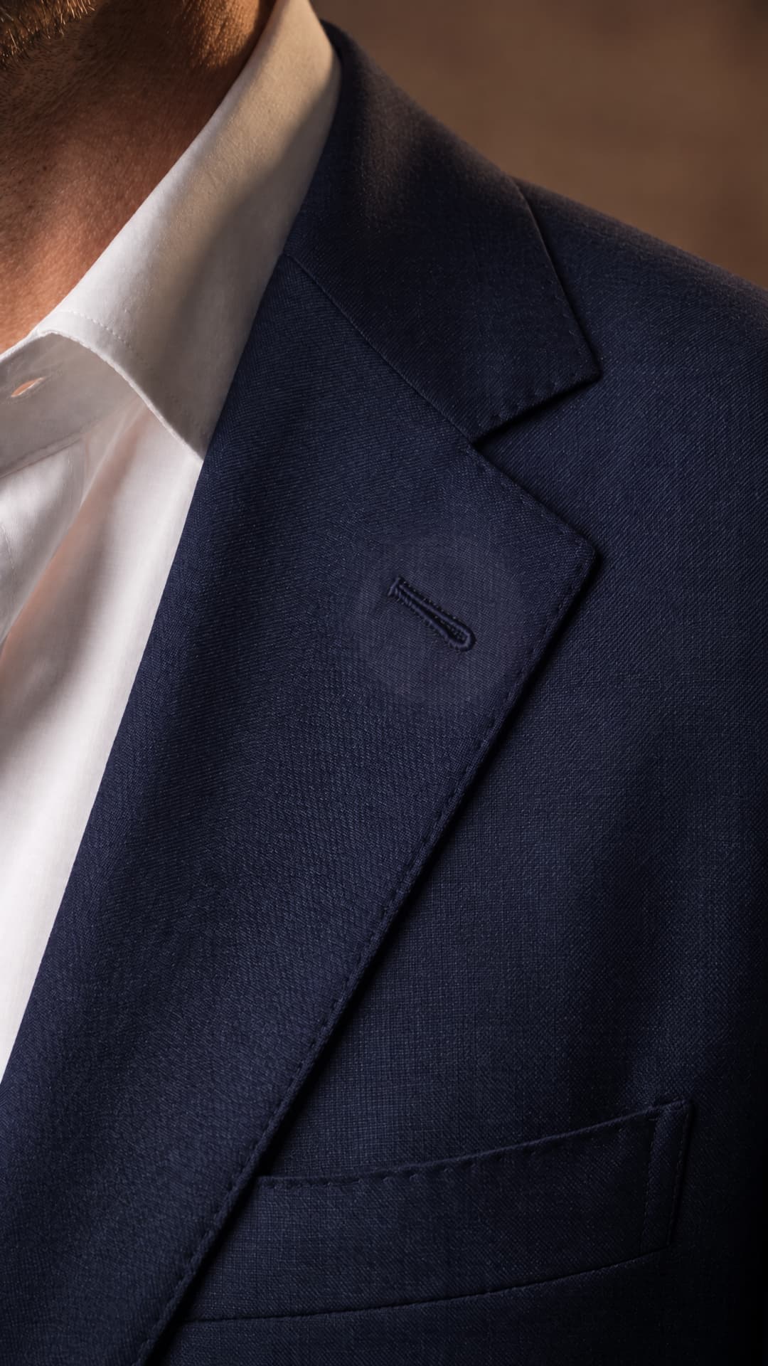 Raised Milanese silk buttonhole on a navy notch lapel