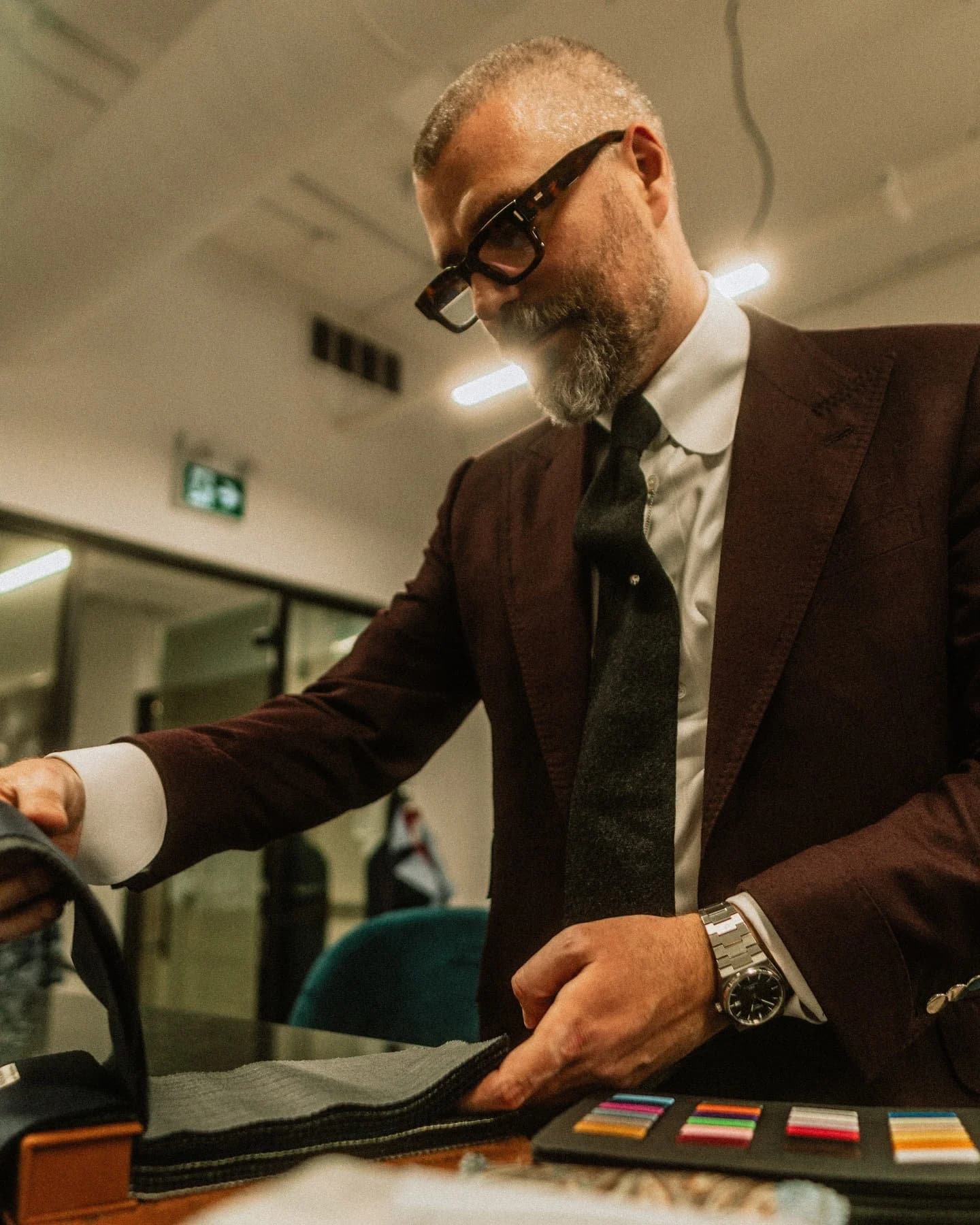 Our in-house cutter and tailor, Ian MacMillan, selecting cloth at the consultation table