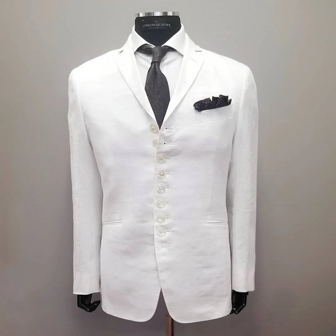 A white linen jacket with nine buttons down the front, made for a client by The London Bespoke Club