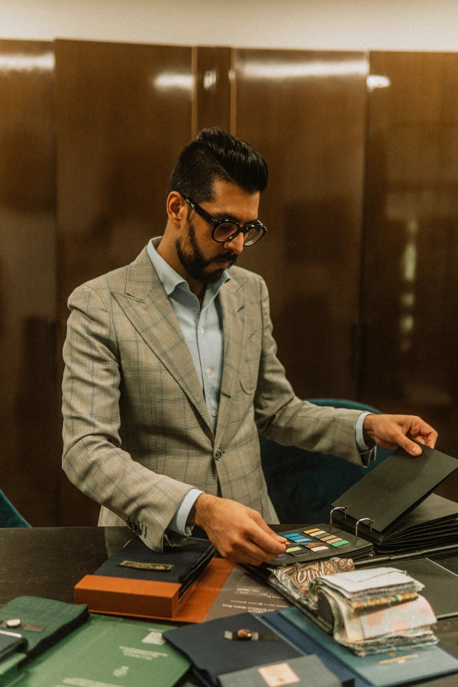 Kunal Arora selecting cloth and planning a suit at The London Bespoke Club