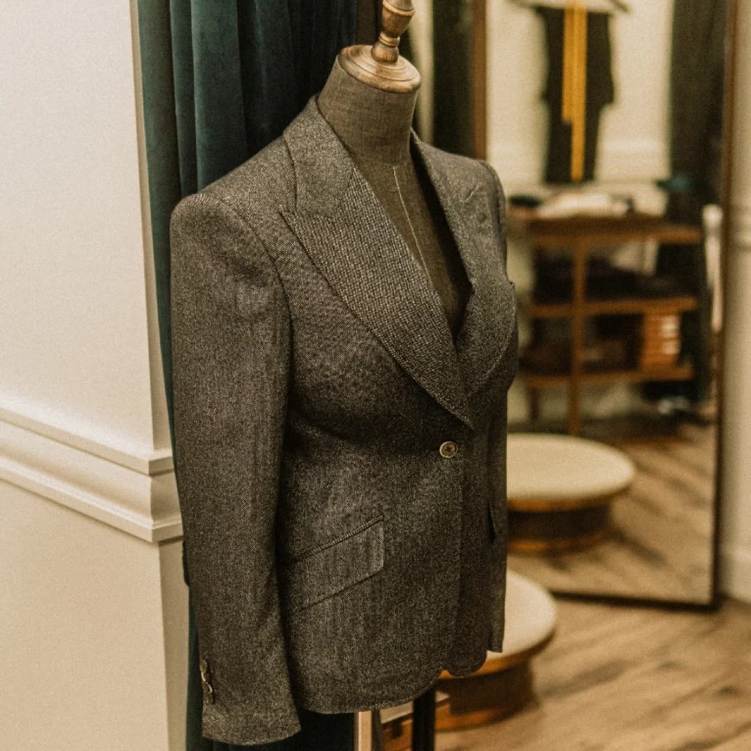 A women’s bench-made blazer with a pronounced pagoda shoulder, made at our Toronto atelier